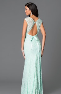 a woman in a mint lace dress with an open back