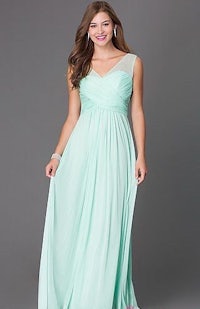 a woman in a mint green long dress is posing for a photo
