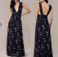 the back view of a woman in a blue and black floral maxi dress