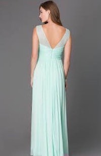 the back view of a woman in a mint green dress